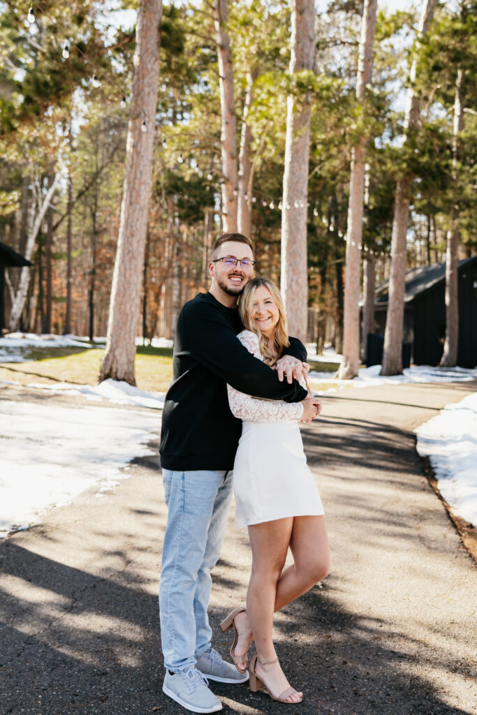 A couple sharing a hug at their wedding venue in Nisswa, MN
